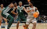 Mississippi State Bulldogs guard Josh Hubbard (13) is defended by Michigan State Spartans guard Tre Holloman (5) in the first round of the 2024 NCAA Tournament at the Spectrum Center - Jim Dedmon, USA TODAY Sports