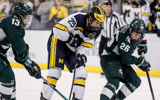 Michigan left wing Dylan Duke is defended by Michigan State right wing Tanner Kelly during the third period at Yost Ice Arena in Ann Arbor on Friday, Feb. 9, 2024 - Junfu Han, USA TODAY Sports