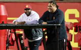 USC defensive line coach Eric Henderson and Shaun Nua watch the Trojans warm up before a spring ball practice
