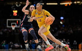 USC Trojans guard JuJu Watkins (12) drives to the basket during the second half against UConn Huskies guard Nika Muhl (10) in the finals of the Portland Regional of the NCAA Tournament at the Moda Center