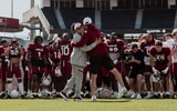 Dawn Staley visits a South Carolina football practice in the spring of 2024 (Photo Credit: Gamecock Football | X)