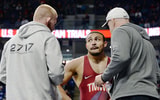 Coaches Bo Nickal, left, and Cael Sanderson, right, talk with Aaron Brooks during his first match at the U.S. Olympic Wrestling Trials at Penn State's Bryce Jordan Center on Friday, April 19, 2024. (Andy Mason/Herald-Mail / USA TODAY NETWORK)
