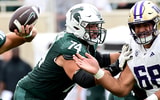 Michigan State Spartans offensive lineman Geno VanDeMark (74) and Washington Huskies defensive lineman Ulumoo Ale (68) battle in the first half at Spartan Stadium. - Dale Young, USA TODAY Sports