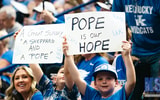 Kentucky fans hold up signs for Mark Pope at his introductory press conference - Aaron Perkins, Kentucky Sports Radio