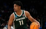 Michigan State Spartans guard A.J. Hoggard (11) controls the ball against the Mississippi State Bulldogs in the first round of the 2024 NCAA Tournament at the Spectrum Center. - Jim Dedmon, USA Today Sports