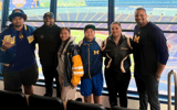 Douglas Utu and family with Michigan coaching staff (Ane Utu/X)