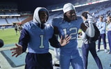 UNC's Thad Dixon and Greg Smith walking off the field.