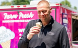 Mark Pope eats ice cream outside the Joe Craft Center