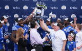 Jan 1, 2022; Orlando, FL, USA; Kentucky Wildcats players and head coach Mark Stoops celebrate after defeating the Iowa Hawkeyes in the 2022 Citrus Bowl at Camping World Stadium. Mandatory Credit: Jasen Vinlove-USA TODAY Sports