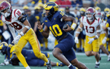 Michigan Wolverines quarterback Alex Orji (10) runs in the second half against the USC Trojans at Michigan Stadium