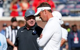 Kentucky Wildcats head coach Mark Stoops (left) and Mississippi Rebels head coach Lane Kiffin (right) talk prior tot the game at Vaught-Hemingway Stadium. Mandatory Credit: Petre Thomas-Imagn Images