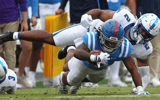 Sep 28, 2024; Oxford, Mississippi, USA; Kentucky Wildcats linebacker Jamon Dumas-Johnson (2) tackles Mississippi Rebels running back Matt Jones (0) during the second half at Vaught-Hemingway Stadium. Mandatory Credit: Petre Thomas-Imagn Images