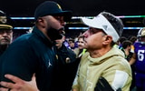 Oct 5, 2024; Seattle, Washington, USA; Michigan Wolverines head coach Sherrone Moore, left, shakes hands with Washington Huskies head coach Jedd Fisch, right, following a Washington victory at Alaska Airlines Field at Husky Stadium. Mandatory Credit: Joe Nicholson-Imagn Images
