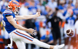 Aug 31, 2024; Gainesville, Florida, USA; Florida Gators punter Jeremy Crawshaw (26) punts the ball against the Miami Hurricanes during the first half at Ben Hill Griffin Stadium. Mandatory Credit: Matt Pendleton-Imagn Images