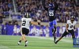 Vanderbilt quarterback Diego Pavia looks to throw the ball with Kentucky defender Jordan Lovett in pursuit - Dr. Michael Huang, Kentucky Sports Radio