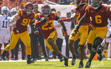 USC linebacker Desman Stephens returns an interception behind blocking from his teammates during a game against Penn State