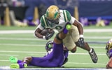 DeSoto's Myson Cook Johnson is tripped up in a Texas high school football game.
