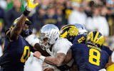 Michigan Wolverines football's defensive line getting to Oregon quarterback Dillon Gabriel in a 38-17 loss to the Ducks. (Photo by Junfu Han / USA TODAY NETWORK via Imagn Images)