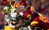Notre Dame Fighting Irish wide receiver Avery Davis (3) is brought down by USC Trojans defensive lineman Stanley Ta'ufo'ou (47) and linebacker Ralen Goforth (10) during the first half at the Los Angeles Memorial Coliseum