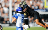 Central Florida Knights cornerback Chasen Johnson (27) is flagged for pass interference against Brigham Young Cougars wide receiver Chase Roberts (2) in the first half at FBC Mortgage Stadium