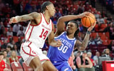 Feb 26, 2025; Norman, Oklahoma, USA; Oklahoma Sooners forward Jalon Moore (14) defends a drive by Kentucky Wildcats guard Otega Oweh (00) during the first half at Lloyd Noble Center. Mandatory Credit: Alonzo Adams-Imagn Images