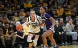 Iowa point guard Lucy Olsen drives to the basket against Northwestern. (Photo by Dennis Scheidt)