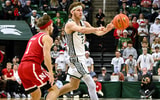Michigan State Spartans guard Gehrig Normand (7) passes to a teammate in front of Nebraska Cornhuskers guard Sam Hoiberg (1) during the second half at Jack Breslin Student Events Center. - Dale Young, USA TODAY Sports
