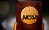 Apr 19, 2025; Fort Worth, TX, USA; A view of the NCAA logo and trophy before the 2025 Women's National Gymnastics Championship at Dickies Arena. Mandatory Credit: Jerome Miron-Imagn Images