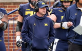 Michigan offensive coordinator Chip Lindsey, left, and offensive line coach Grant Newsome watch warm up before the spring game at Michigan Stadium in Ann Arbor on Saturday, April 19, 2025.
