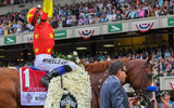 Mike Smith celebrates a Triple Crown win aboard Justify in 2018, via Dennis Schneidler-Imagn Images