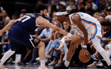 May 11, 2025; Denver, Colorado, USA; Oklahoma City Thunder guard Shai Gilgeous-Alexander (2) controls the ball as Denver Nuggets guard Jamal Murray (27) guards in the third quarter during game four of the second round of the 2025 NBA Playoffs at Ball Arena. Mandatory Credit: Isaiah J. Downing-Imagn Images