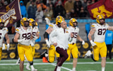 Jan 3, 2025; Charlotte, NC, USA; Minnesota Golden Gophers head coach P.J. Fleck leads his team onto the field during the first quarter against the Virginia Tech Hokies at the DukesÕ Mayo Bowl at Bank of America Stadium. Mandatory Credit: Jim Dedmon-Imagn Images