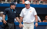 Texas softball coach Mike White with an umpire at the WCWS