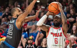 Aaron Harrison attempts to block a shot by Russ Smith in the TBT, via Clare Grant:Courier Journal : USA TODAY NETWORK
