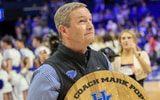 Kentucky athletic director Mitch Barnhart holds a commemorative bourbon barrel top following Mark Pope's first win as head coach - Mont Dawson, Kentucky Sports Radio