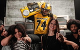 Braylon Ellison points to the camera with his family, including his father, Atiyyah Ellison, and brother, Tyson Ellison (Photo by Mizzou Football)