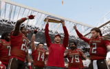 Texas Tech head coach Joey McGuire holds up national championship trophy