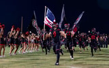 Liberty Lions run onto the field prior to an Arizona high school football game against the Centennial Huskies.
