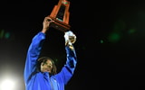 Miami Northwestern coach Teddy Bridgewater holding the state championship trophy.