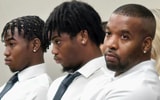 Bishop McCort Catholic Academy student-athletes Julius Reed and Zymir Reed along with their father, Antwuan Reed.