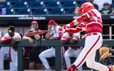 Jun 18, 2025; Omaha, Neb, USA; Louisville Cardinals catcher Tagger Tyson (36) hits a single against the Coastal Carolina Chanticleers during the ninth inning at Charles Schwab Field. Mandatory Credit: Dylan Widger-Imagn Images
