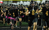 The Southeast Polk Rams take the field before an Iowa high school football game against the Waukee Warriors.