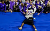 Brownsburg Bulldogs football player leaps into the stands after an Indiana high school football game.