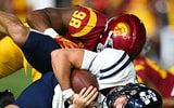 USC Trojans defensive end Devan Thompkins (98) sacks Utah State Aggies quarterback Bryson Barnes (16) during the third quarter at United Airlines Field at Los Angeles Memorial Coliseum