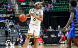Wayne Memorial guard and Michigan State commit Carlos Medlock Jr. moves the ball against Flint Carman-Ainsworth during the second quarter in the Division 1 state semifinal on Friday, March 14, 2025. - Nick King, USA TODAY Sports