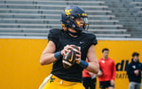 West Virginia quarterback Scotty Fox drops back to pass