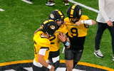 Beau Pribula (9) and Matt Zollers (5) try to punch the ball away from Sam Horn (21)