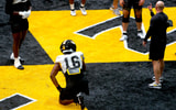 Javion Hilson (16) gets coached by Missouri DEs coach Brian Early (right) during a drill