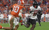 Nov 2, 2024; Clemson, South Carolina, USA; Louisville Cardinals running back Isaac Brown (25) runs the ball against Clemson Tigers cornerback Jeadyn Lukus (10) during the second quarter at Memorial Stadium. Mandatory Credit: Ken Ruinard-Imagn Images