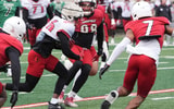 Louisville Duke Watson (26) catches the ball and ran from some yardage against Red Louisville Rodney Johnson (7) in the Spring Game Friday night at L & N Stadium. April 11, 2025